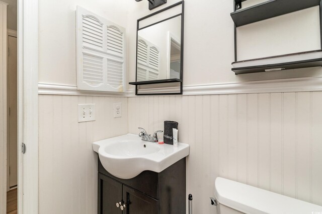 bathroom with vanity, wood-type flooring, and toilet