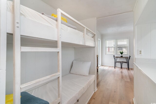 bedroom featuring light hardwood / wood-style flooring and ornamental molding