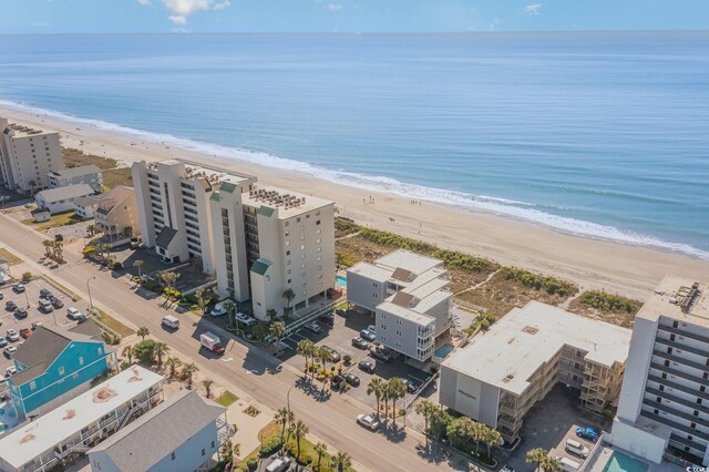 birds eye view of property with a water view and a view of the beach