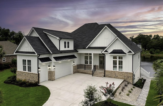 view of front of house with a yard and a garage