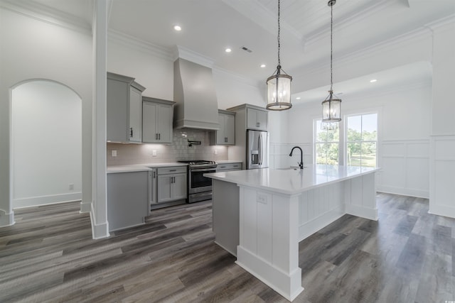 kitchen with dark hardwood / wood-style flooring, stainless steel appliances, hanging light fixtures, and custom exhaust hood