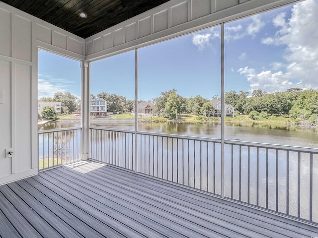 unfurnished sunroom with a water view