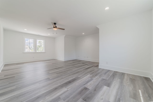 empty room with light wood-type flooring and ceiling fan