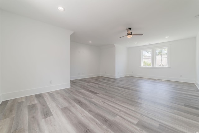 empty room featuring light wood-type flooring and ceiling fan