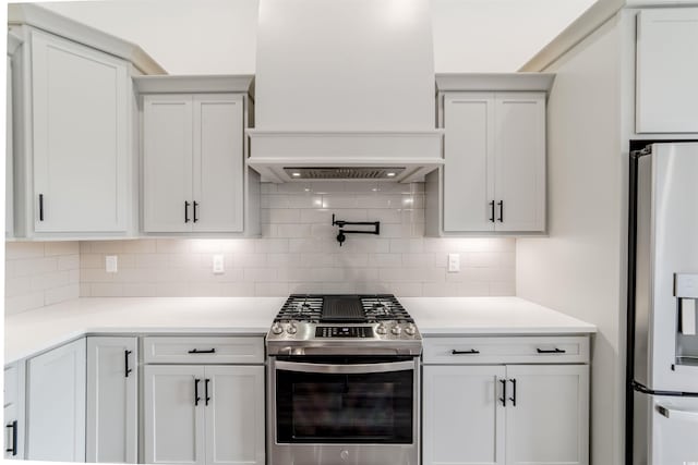 kitchen with appliances with stainless steel finishes, backsplash, and white cabinetry