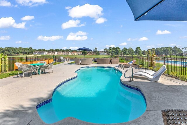 view of swimming pool with outdoor lounge area and a patio area