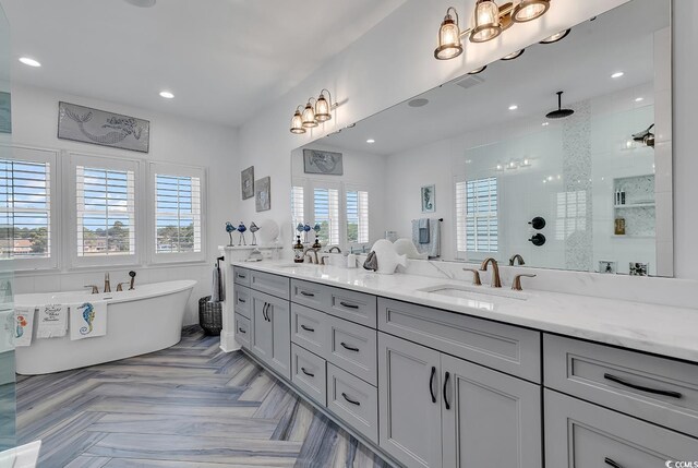 bathroom with vanity, parquet flooring, and separate shower and tub