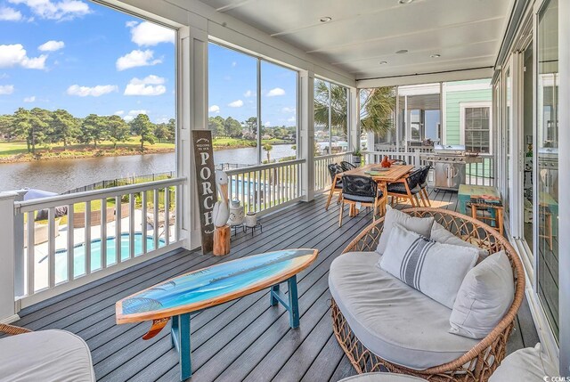 sunroom with a water view and plenty of natural light