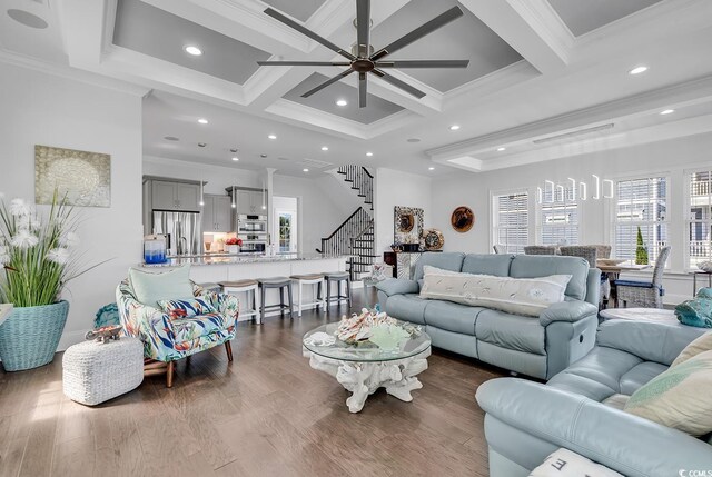 living room with dark hardwood / wood-style flooring, coffered ceiling, ornamental molding, and beamed ceiling