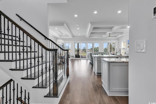 corridor with coffered ceiling, ornamental molding, dark hardwood / wood-style floors, and beamed ceiling