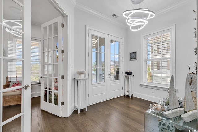 doorway to outside featuring crown molding, dark wood-type flooring, and french doors