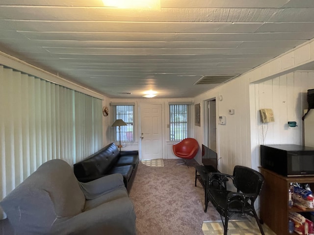carpeted living area featuring visible vents