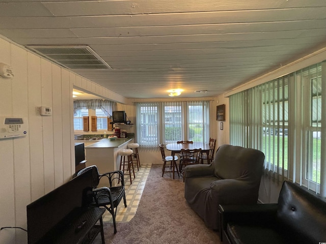 living area with carpet floors and visible vents