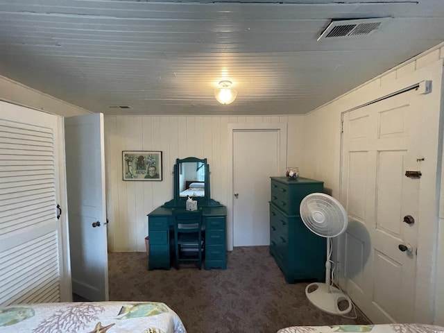 carpeted bedroom featuring visible vents