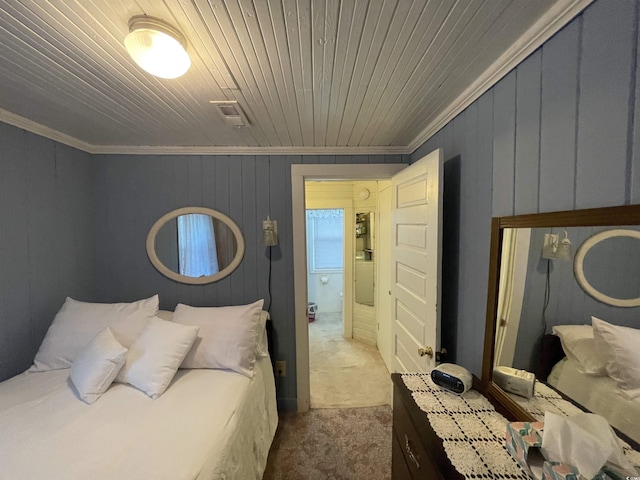 carpeted bedroom with crown molding, wood ceiling, and visible vents