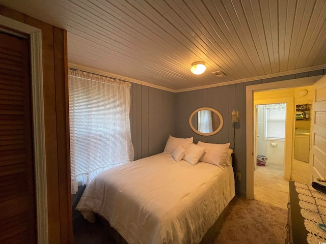 carpeted bedroom with crown molding and wooden ceiling