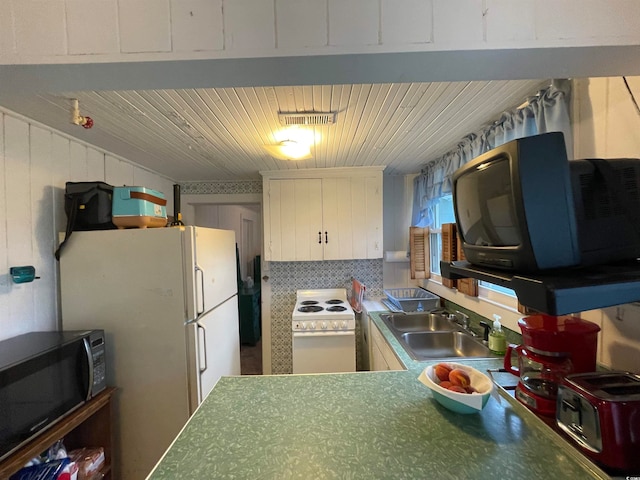 kitchen with white appliances, sink, and tasteful backsplash