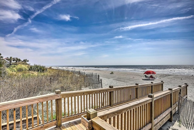 wooden deck with a view of the beach and a water view