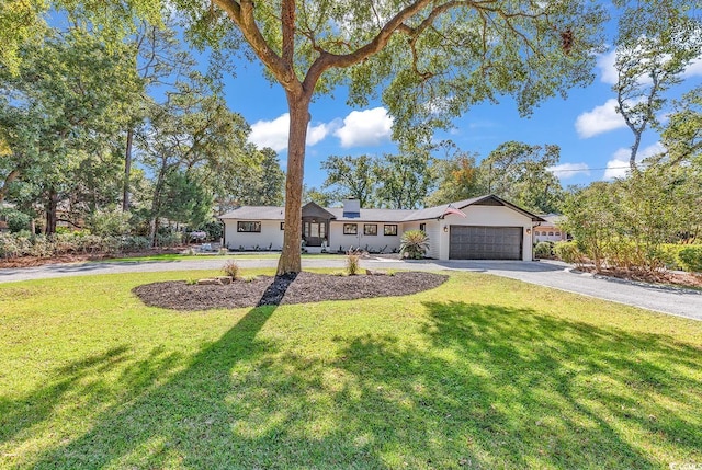 ranch-style house with a front lawn and a garage