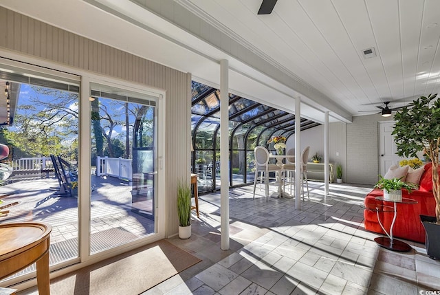 sunroom featuring ceiling fan