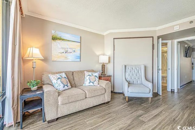 living room featuring hardwood / wood-style floors, crown molding, and a textured ceiling