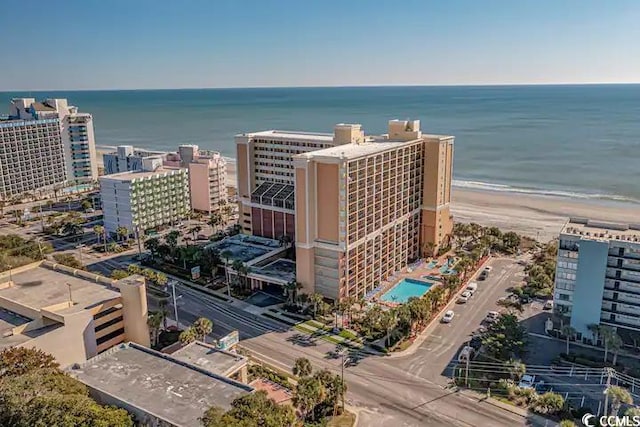 birds eye view of property featuring a water view and a beach view