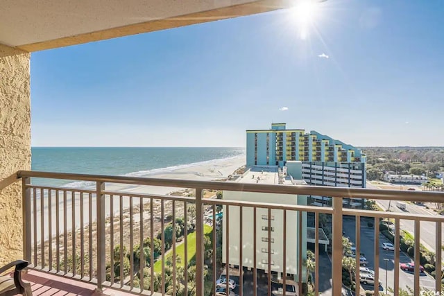 balcony with a water view and a beach view