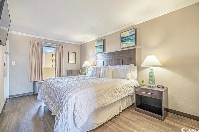 bedroom with crown molding and hardwood / wood-style flooring