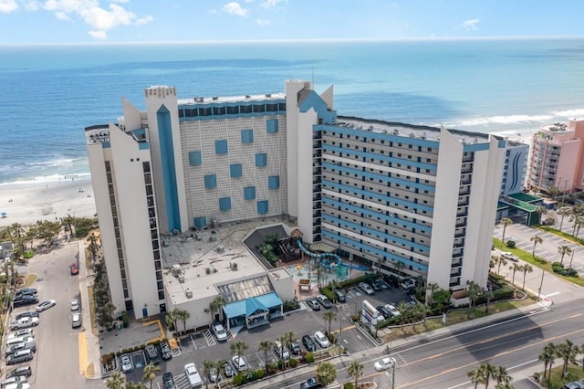 birds eye view of property with a beach view and a water view