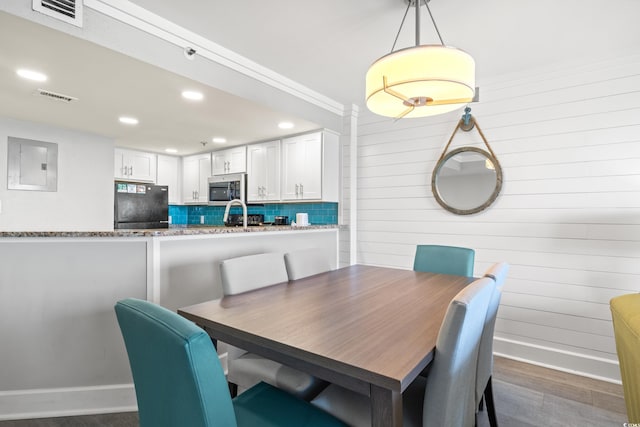 dining area with dark hardwood / wood-style flooring and electric panel