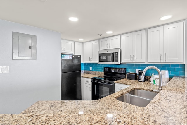 kitchen featuring tasteful backsplash, white cabinetry, sink, electric panel, and black appliances