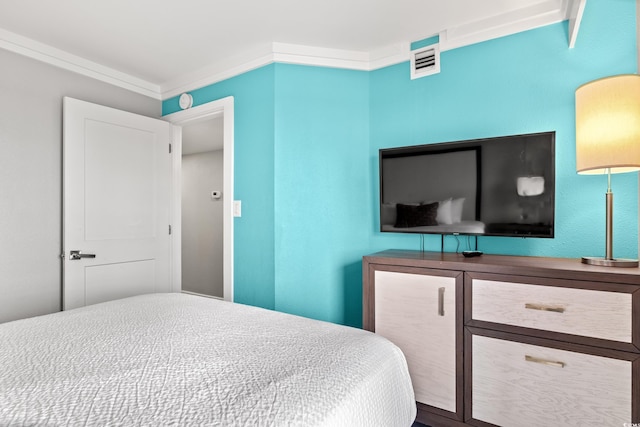 bedroom with ornamental molding