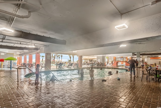 view of swimming pool with a water view