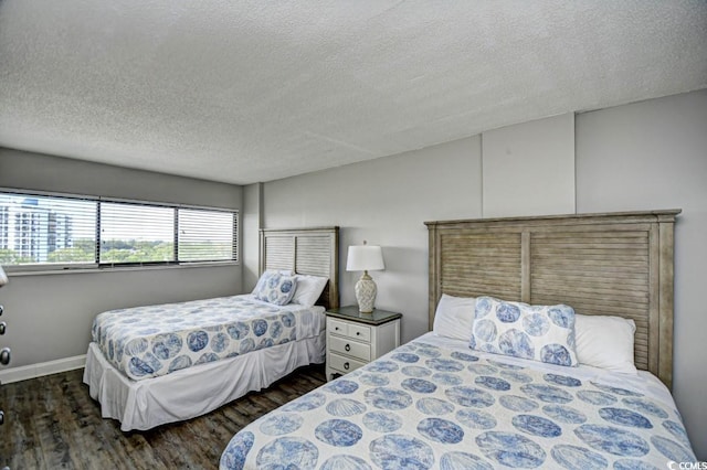 bedroom featuring dark hardwood / wood-style floors and a textured ceiling