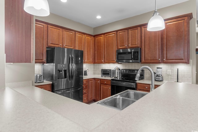 kitchen featuring appliances with stainless steel finishes, tasteful backsplash, and pendant lighting