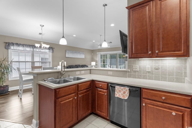 kitchen with light hardwood / wood-style flooring, backsplash, stainless steel dishwasher, kitchen peninsula, and sink