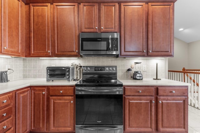 kitchen featuring appliances with stainless steel finishes, backsplash, and light tile patterned floors