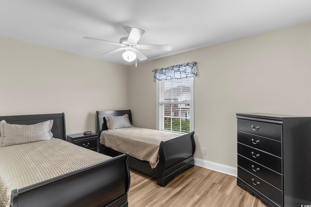 bedroom with light hardwood / wood-style flooring and ceiling fan