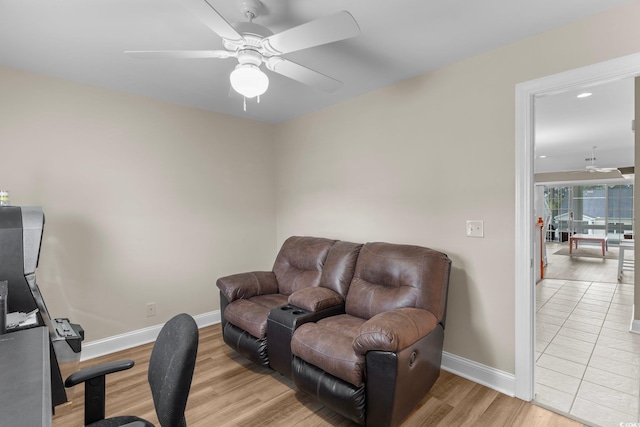 living room with ceiling fan and light tile patterned flooring