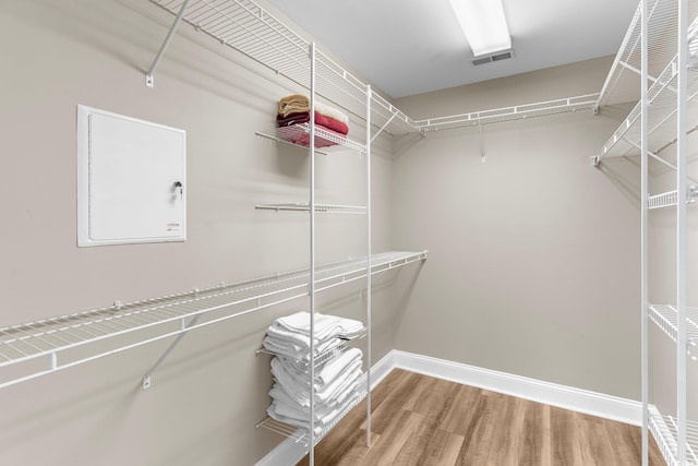 walk in closet with hardwood / wood-style floors