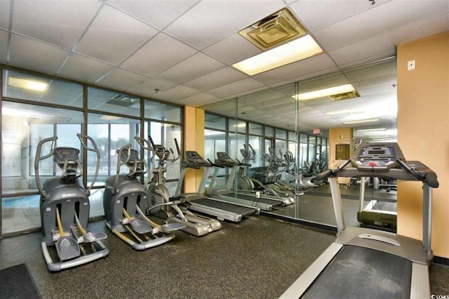 exercise room featuring a drop ceiling