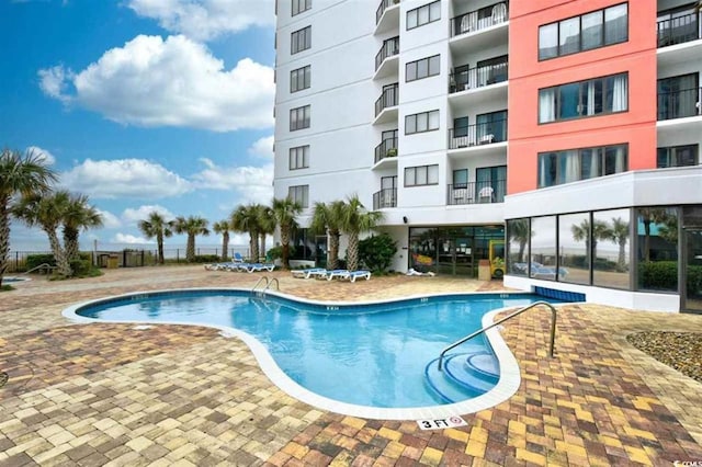 view of swimming pool featuring a patio area