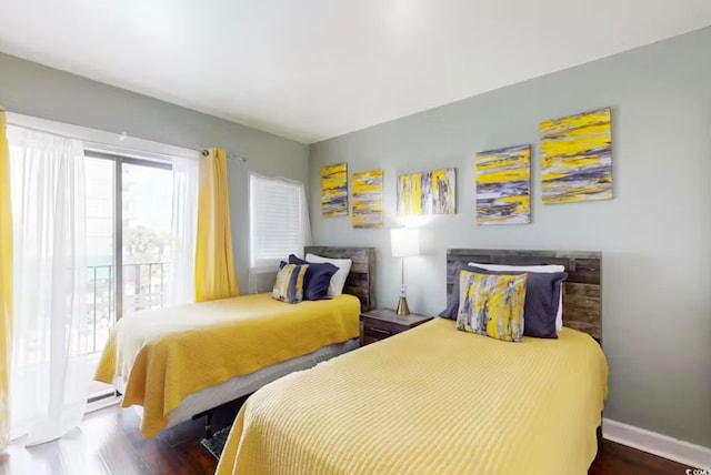 bedroom featuring dark hardwood / wood-style floors and a baseboard heating unit