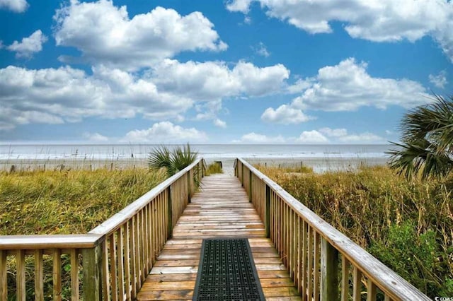 view of property's community featuring a beach view and a water view