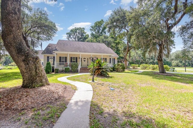 view of front of property with covered porch and a front lawn