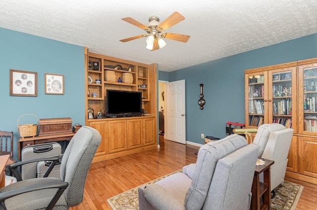 office space with a textured ceiling, light hardwood / wood-style floors, and ceiling fan