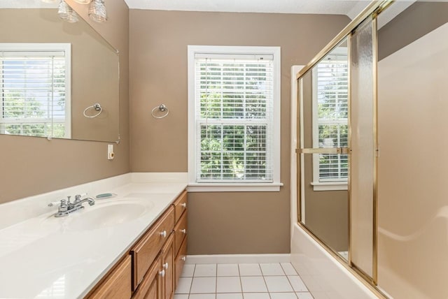 bathroom featuring vanity, shower / bath combination with glass door, and tile patterned flooring