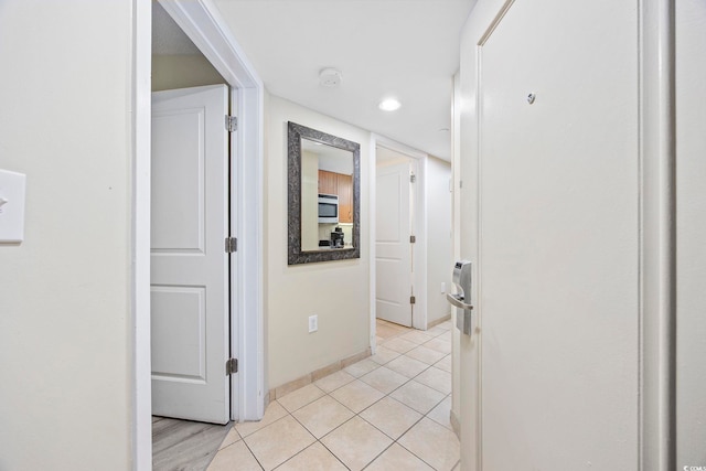 corridor with light tile patterned floors