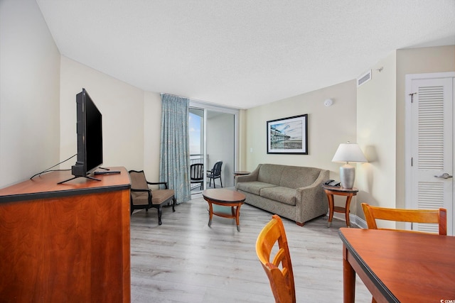 201 S Ocean Blvd Unit 1005, Myrtle Beach, SC 29577 - living area featuring a textured ceiling, visible vents, and light wood-style flooring
