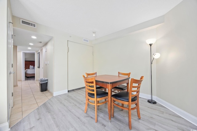 201 S Ocean Blvd Unit 1005, Myrtle Beach, SC 29577 - dining room with visible vents, light wood-style flooring, and baseboards